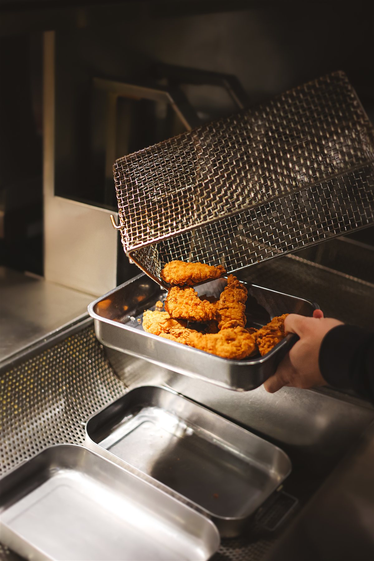 Tenders croustillants sortant de la friteuse en cuisine